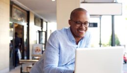 handsome african businessman working with laptop