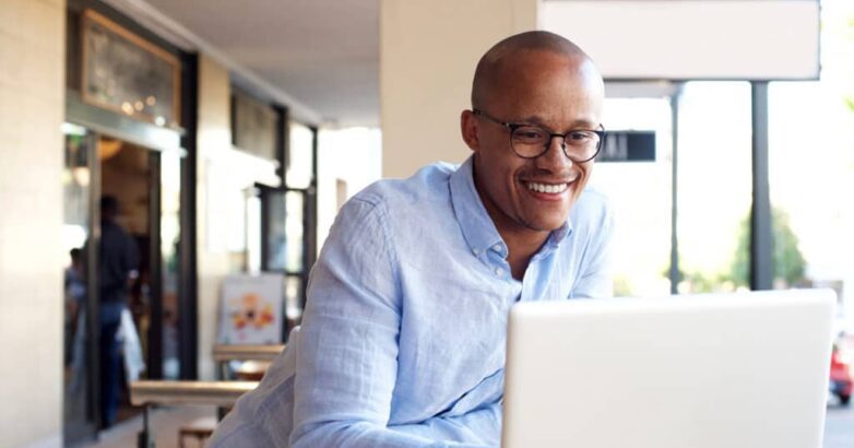 handsome african businessman working with laptop