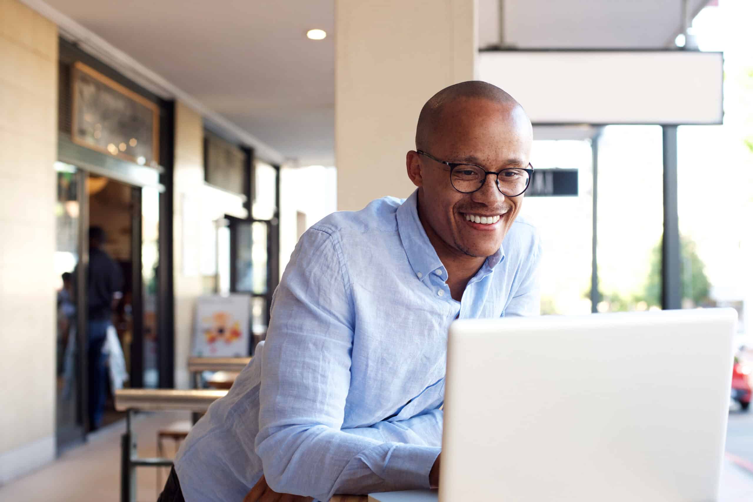 handsome african businessman working with laptop