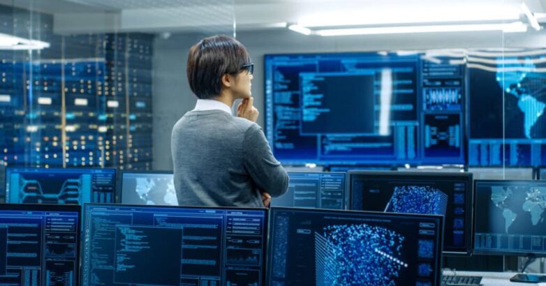 In the System Control Room Technical Operator Stands and Monitor