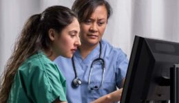 Medical team reading computer screen together