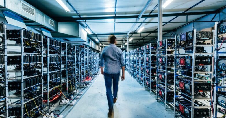 IT business owner walking in high tech data center full of servers and computers.
