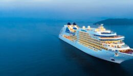 Aerial view of beautiful white cruise ship above luxury cruise i