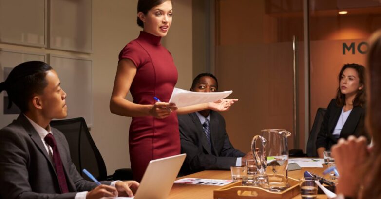 Business professional presenting tech solutions to C-suite